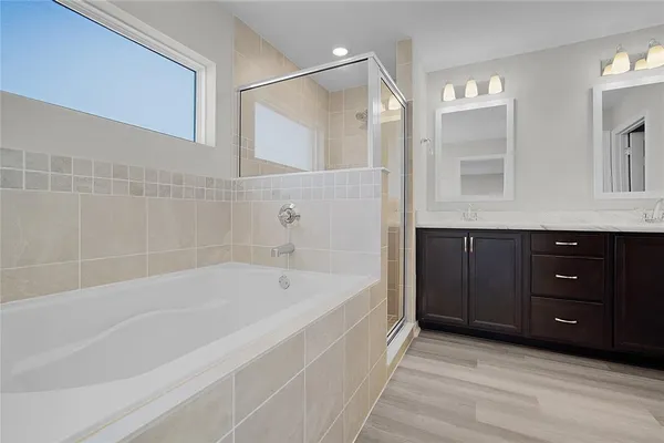a bathroom with a shower sink and mirror