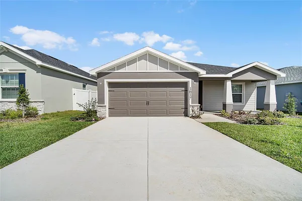 a front view of a house with a yard and garage