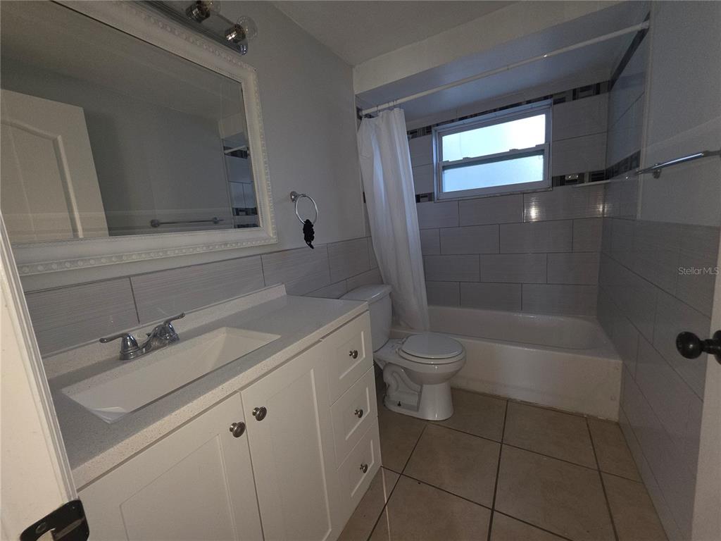 1344 Wickham Lane Holiday, FL 34691 - Photo 15 of 17 a bathroom with a sink a toilet and shower