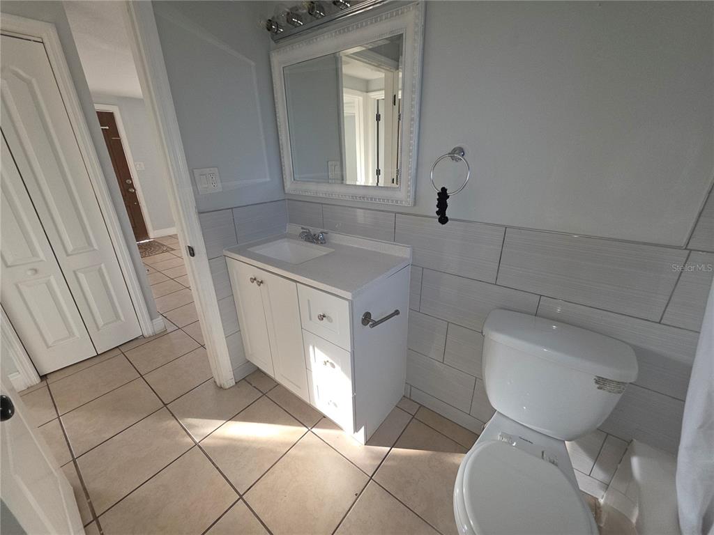 1344 Wickham Lane Holiday, FL 34691 - Photo 17 of 17 a bathroom with a sink toilet and mirror