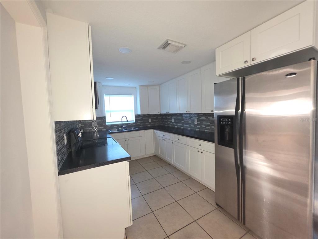 1344 Wickham Lane Holiday, FL 34691 - Photo 3 of 17 a large bathroom with a large mirror