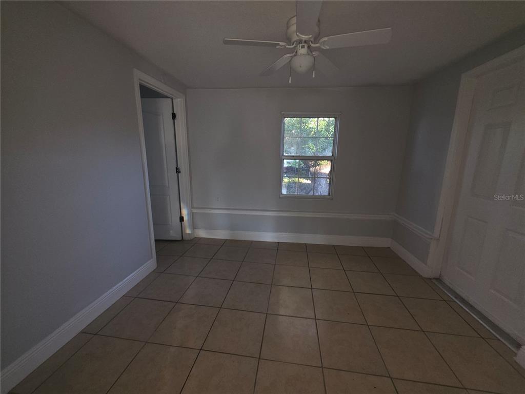 1344 Wickham Lane Holiday, FL 34691 - Photo 9 of 17 an empty room with a empty space and windows