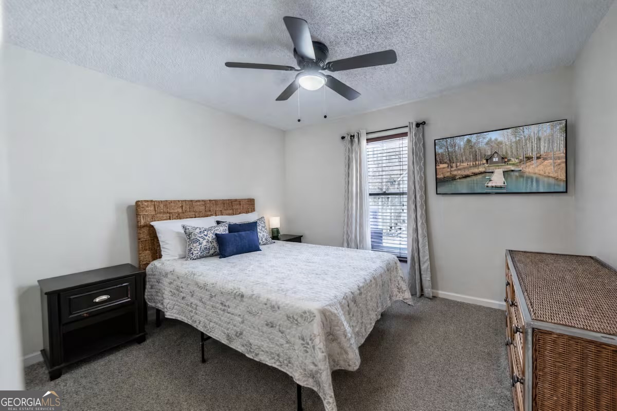 68 Franklin Road Eatonton, GA 31024 - Photo 20 of 28 a bedroom with a bed and a chandelier