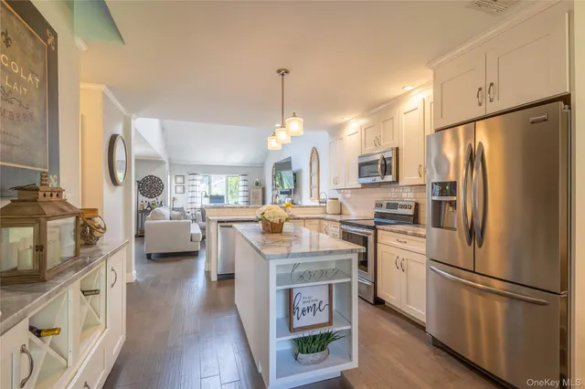 a kitchen with cabinets and stainless steel appliances