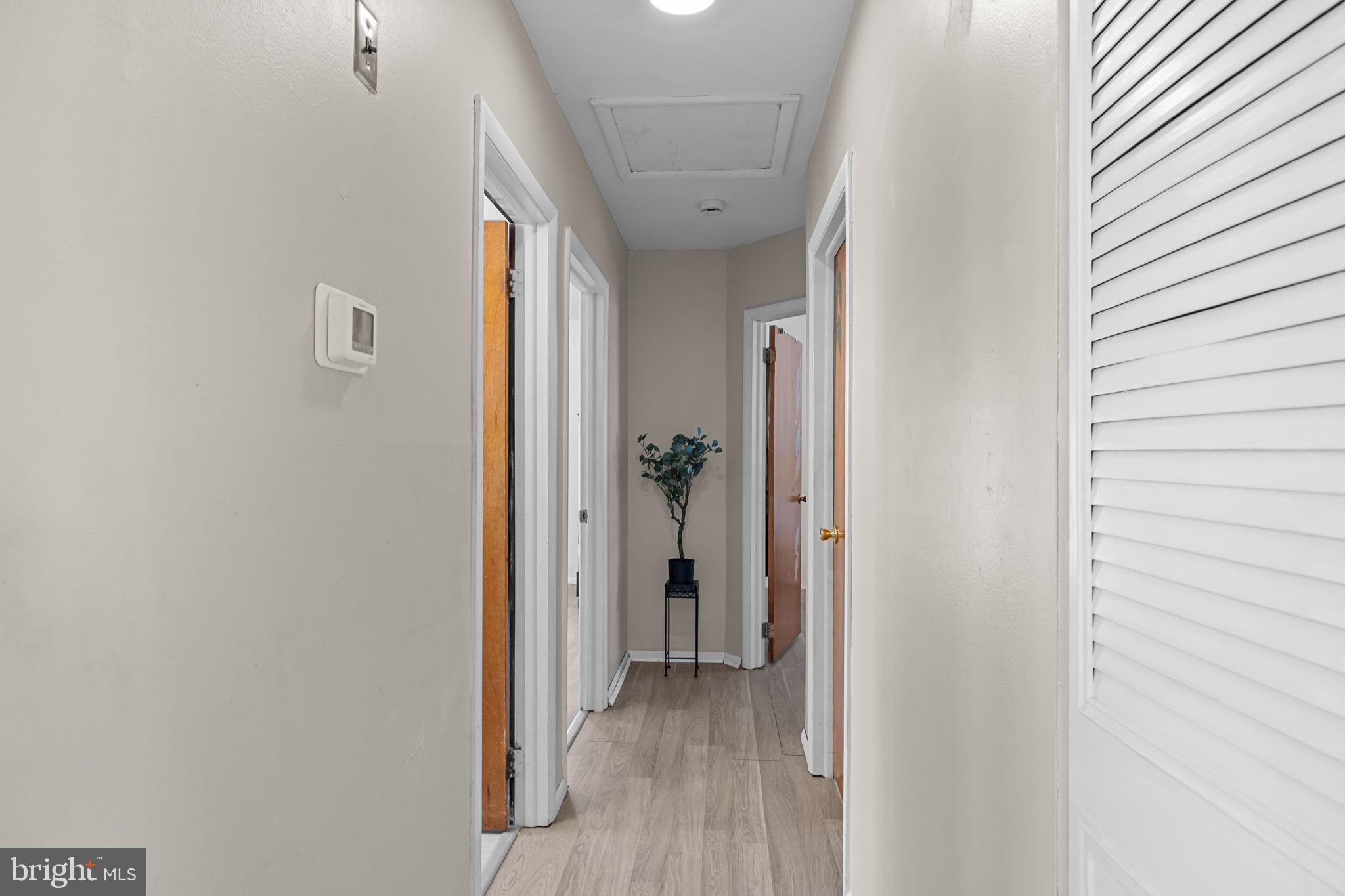 17 Capella Road Sewell, NJ 08080 - Photo 16 of 32 a view of a hallway with wooden floor and a bathroom
