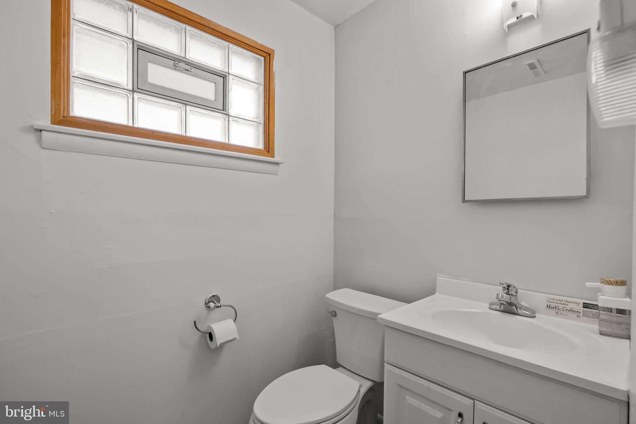 17 Capella Road Sewell, NJ 08080 - Photo 28 of 32 a bathroom with a toilet sink vanity and mirror
