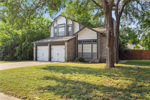 a view of a house with yard and tree s
