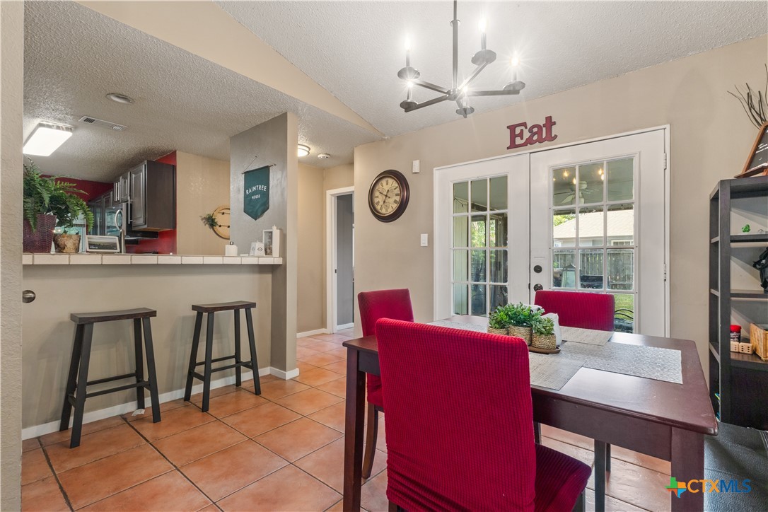 2107 Raintree Path Round Rock, TX 78664 - Photo 13 of 35 a view of a dining room with furniture and a chandelier