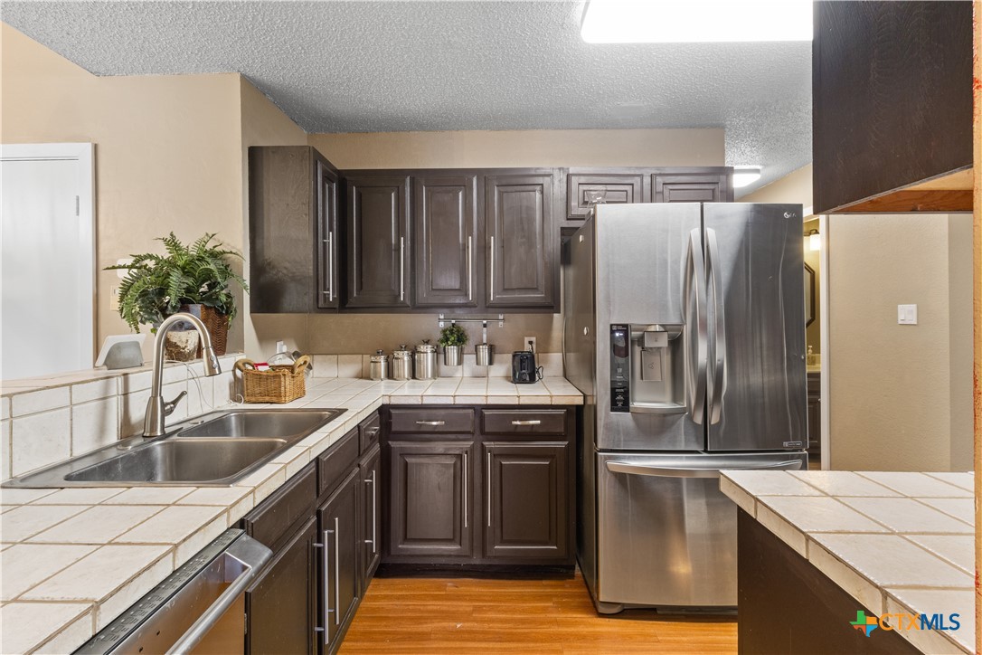 2107 Raintree Path Round Rock, TX 78664 - Photo 16 of 35 a kitchen with stainless steel appliances granite countertop a sink stove and refrigerator