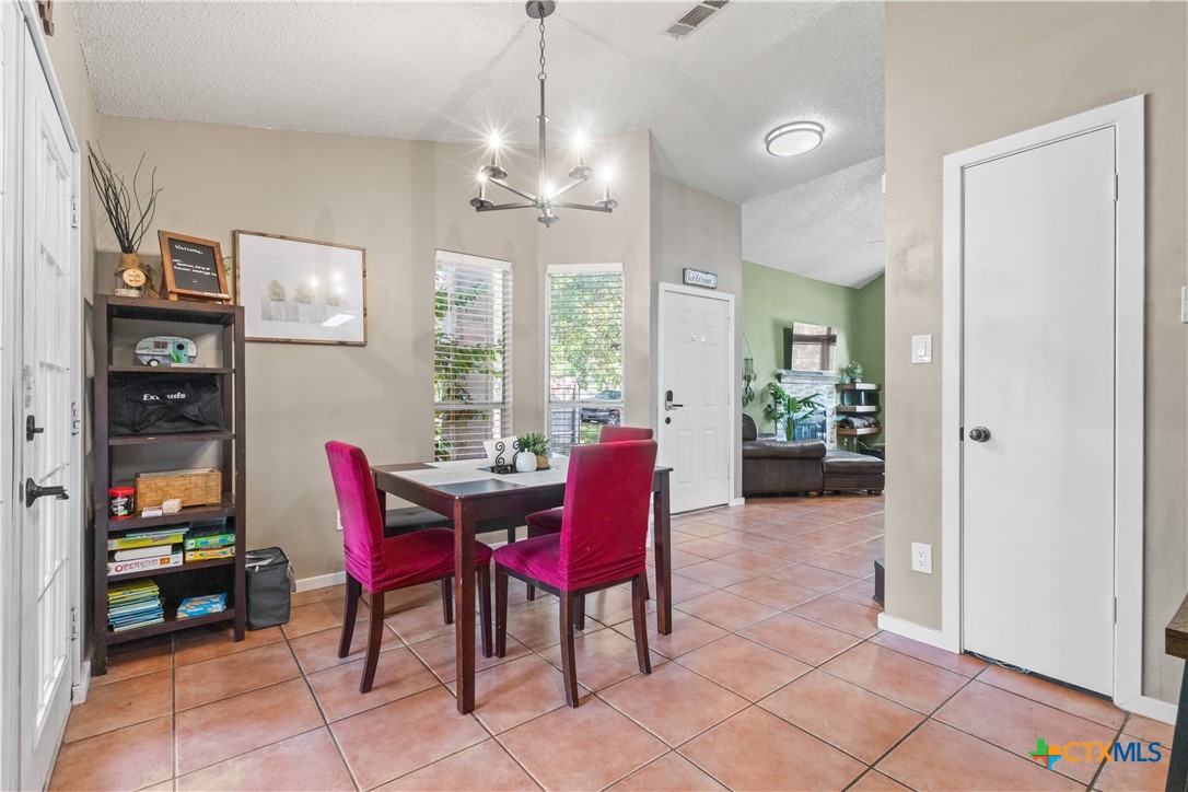 2107 Raintree Path Round Rock, TX 78664 - Photo 19 of 35 a view of a dining room with furniture and chandelier