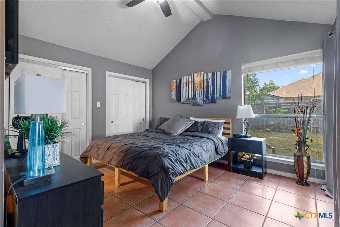 2107 Raintree Path Round Rock, TX 78664 - Photo 20 of 35 a bedroom with a bed table and a window
