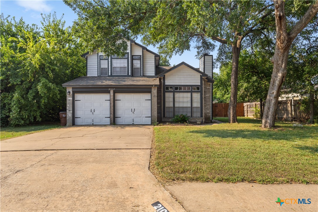 2107 Raintree Path Round Rock, TX 78664 - Photo 2 of 35 a front view of a house with a yard and garage