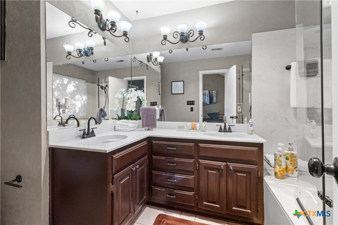 2107 Raintree Path Round Rock, TX 78664 - Photo 23 of 35 a bathroom with a sink double vanity and a mirror