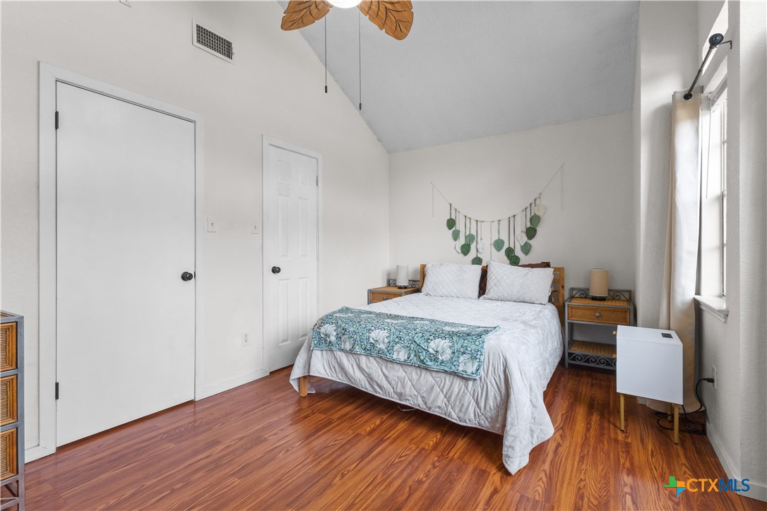 2107 Raintree Path Round Rock, TX 78664 - Photo 26 of 35 a bedroom with a bed and wooden floor