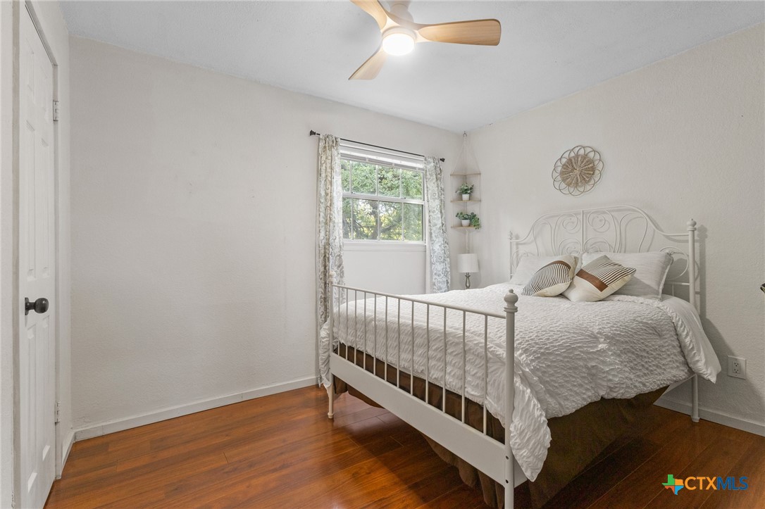 2107 Raintree Path Round Rock, TX 78664 - Photo 28 of 35 a bed sitting in a bedroom next to a window