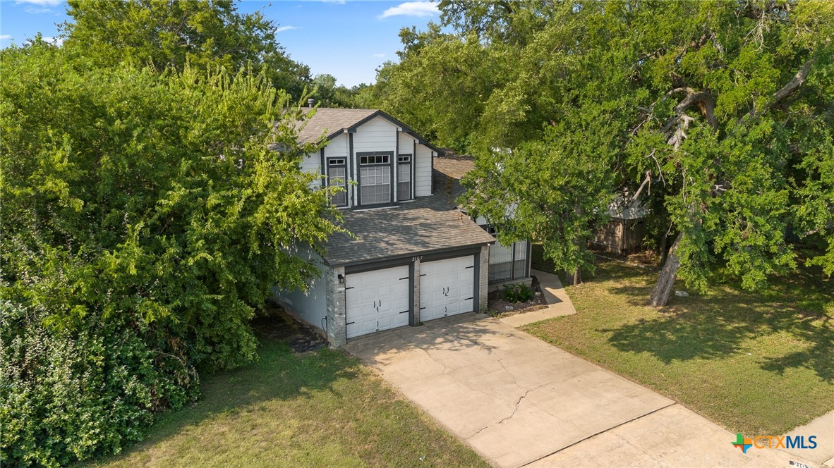 2107 Raintree Path Round Rock, TX 78664 - Photo 3 of 35 a front view of a house with a yard and garage