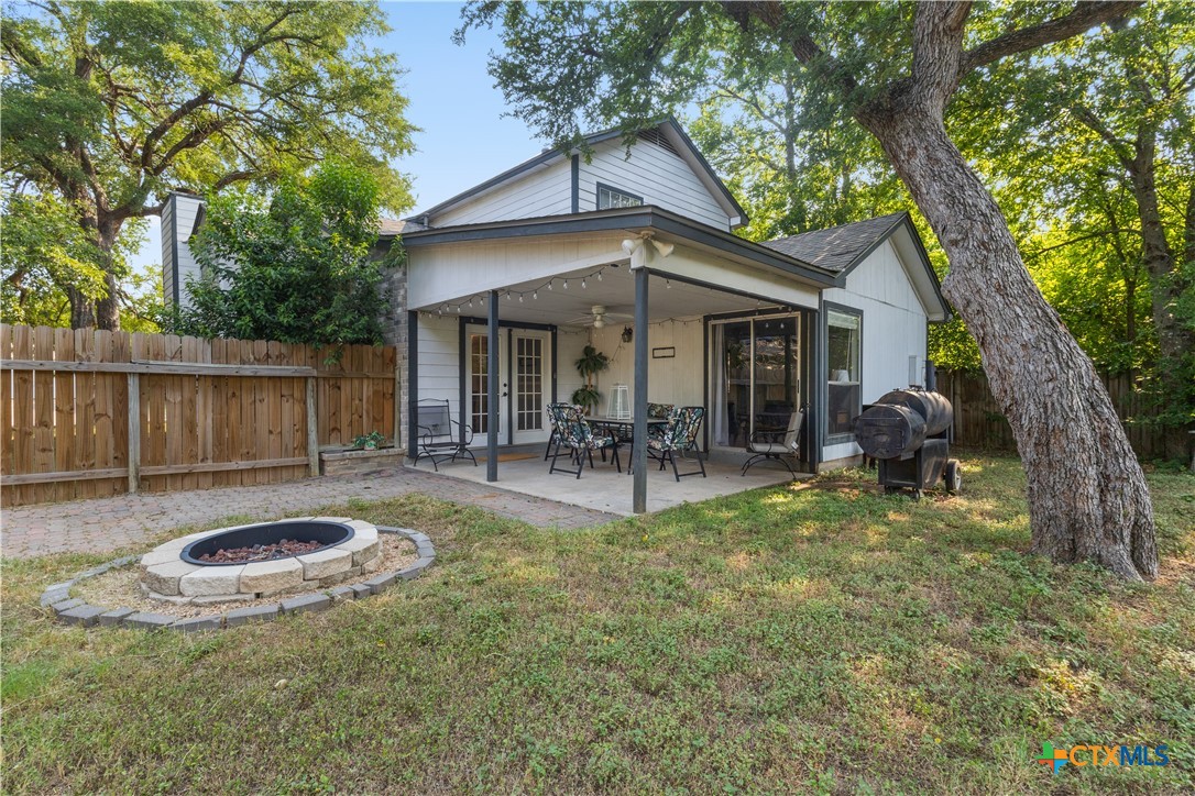 2107 Raintree Path Round Rock, TX 78664 - Photo 31 of 35 a view of a patio with table and chairs potted plants and large tree