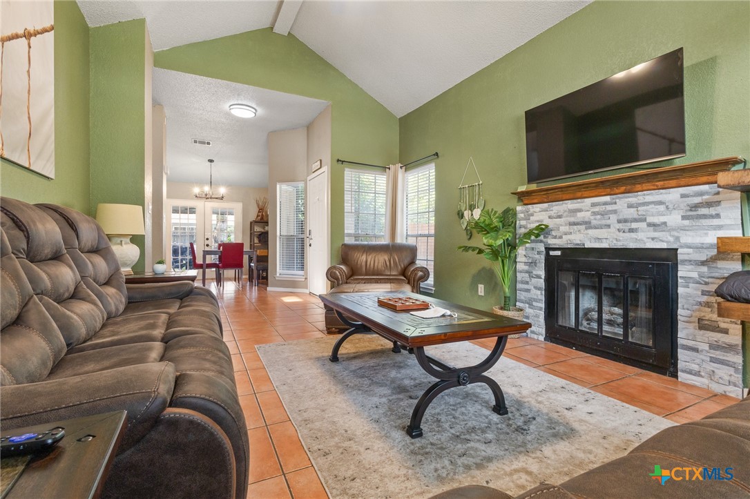 2107 Raintree Path Round Rock, TX 78664 - Photo 10 of 35 a living room with furniture a flat screen tv and a fireplace