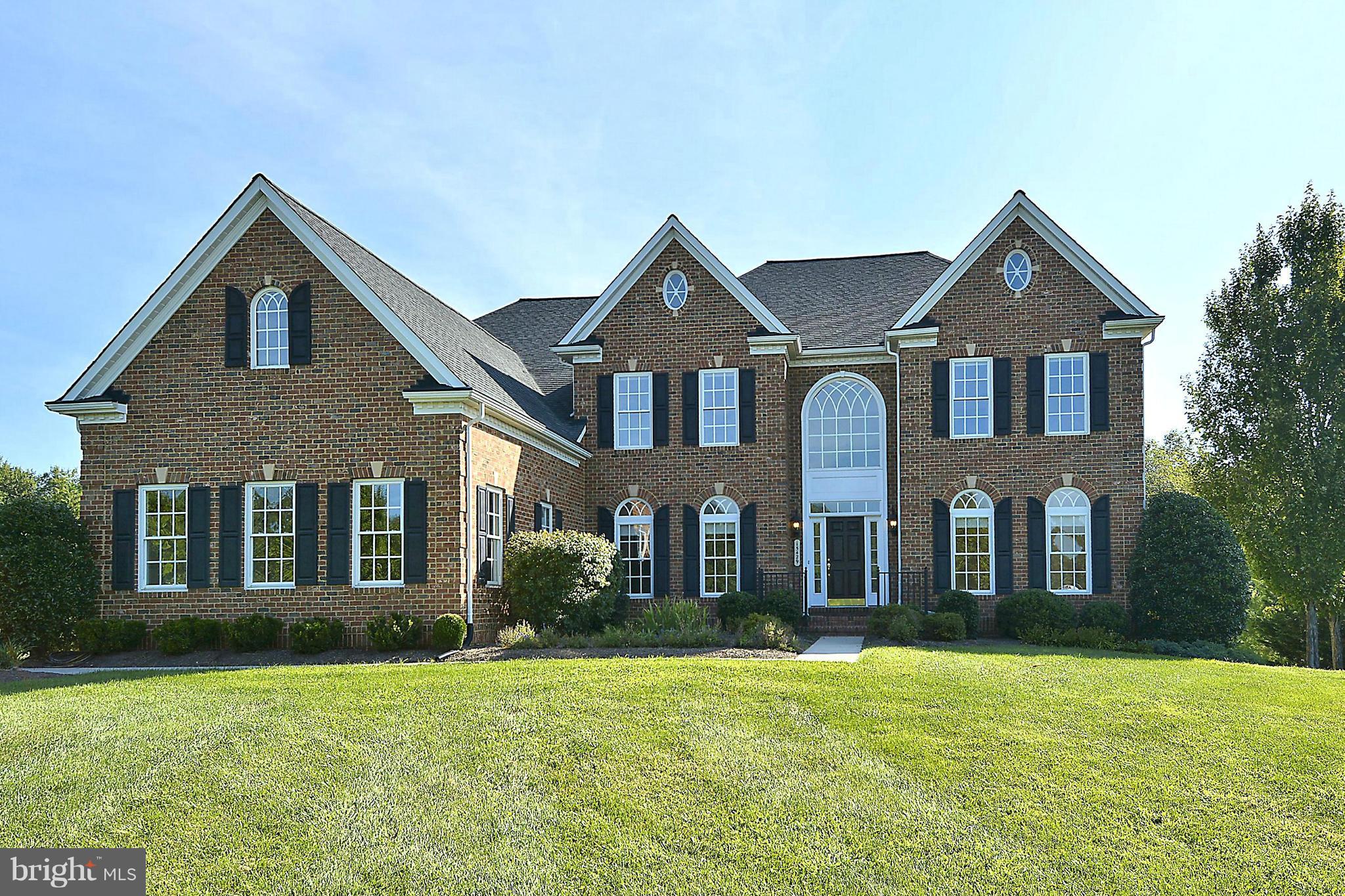 15429 Maple Ridge Drive Woodbine, MD 21797 - Photo 1 of 30 front view of brick house with a yard