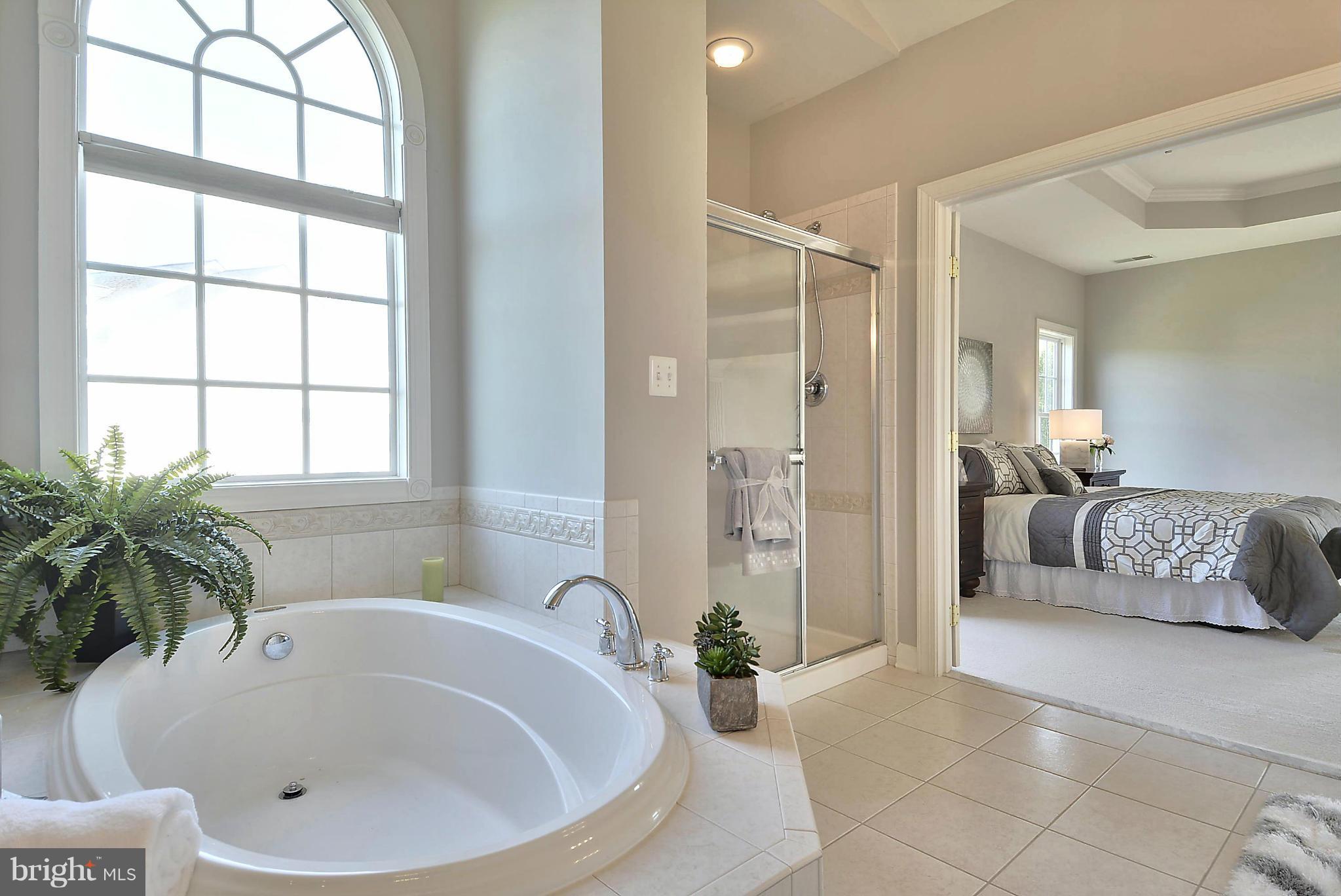 15429 Maple Ridge Drive Woodbine, MD 21797 - Photo 15 of 30 a white bath tub sitting in a bathroom next to a window