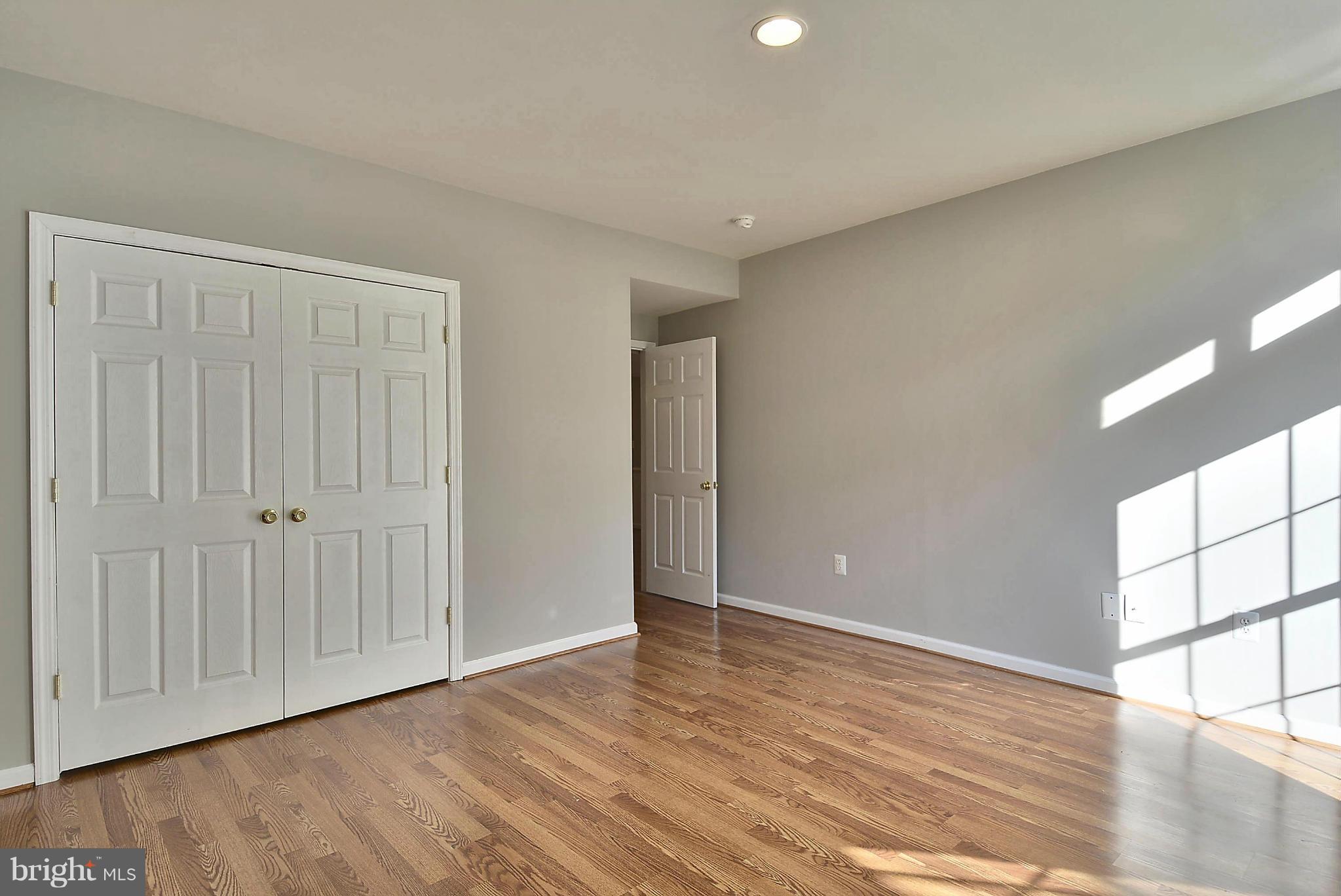 15429 Maple Ridge Drive Woodbine, MD 21797 - Photo 23 of 30 a view of an empty room with wooden floor and a window