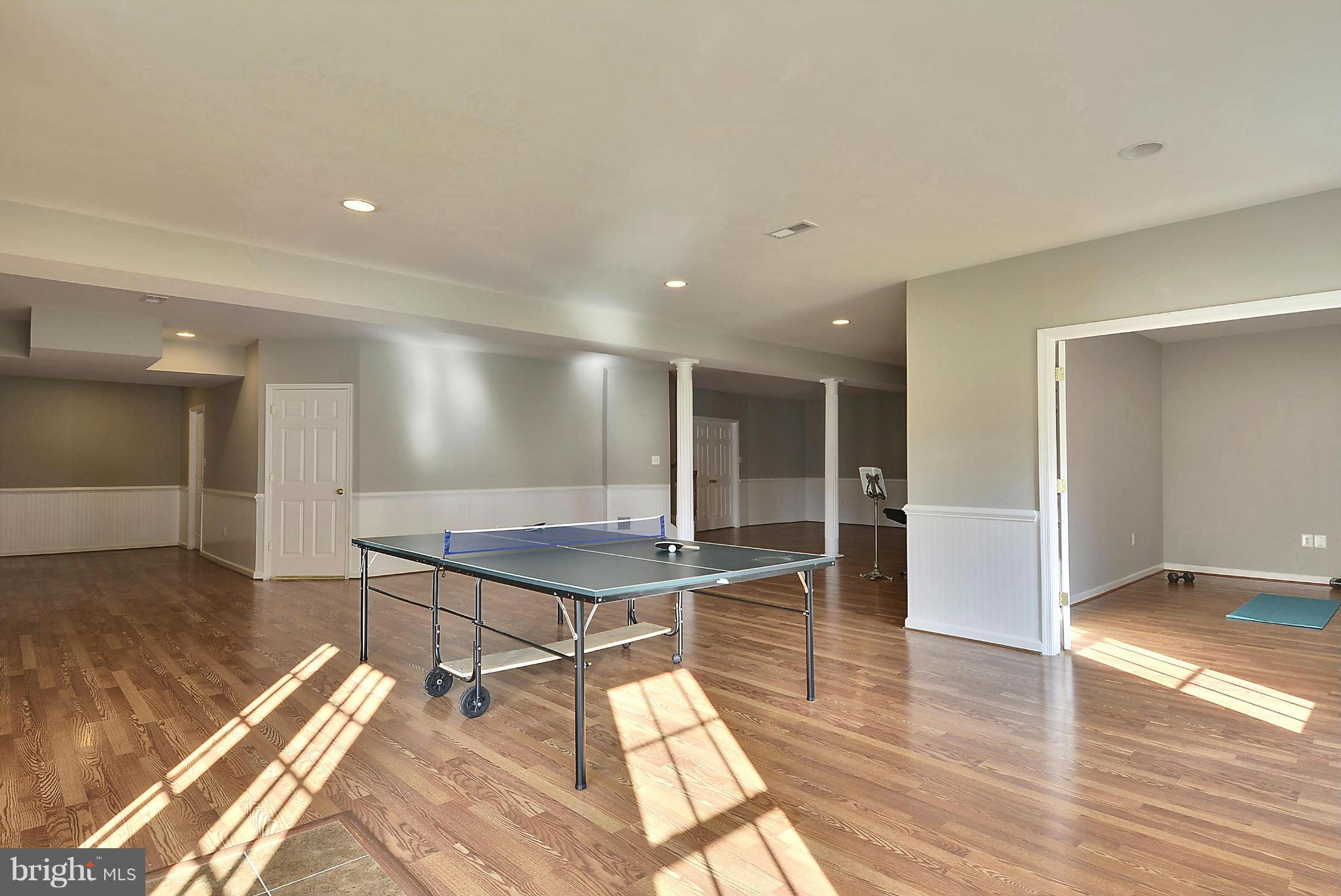 15429 Maple Ridge Drive Woodbine, MD 21797 - Photo 26 of 30 a room with wooden floor a table and kitchen view