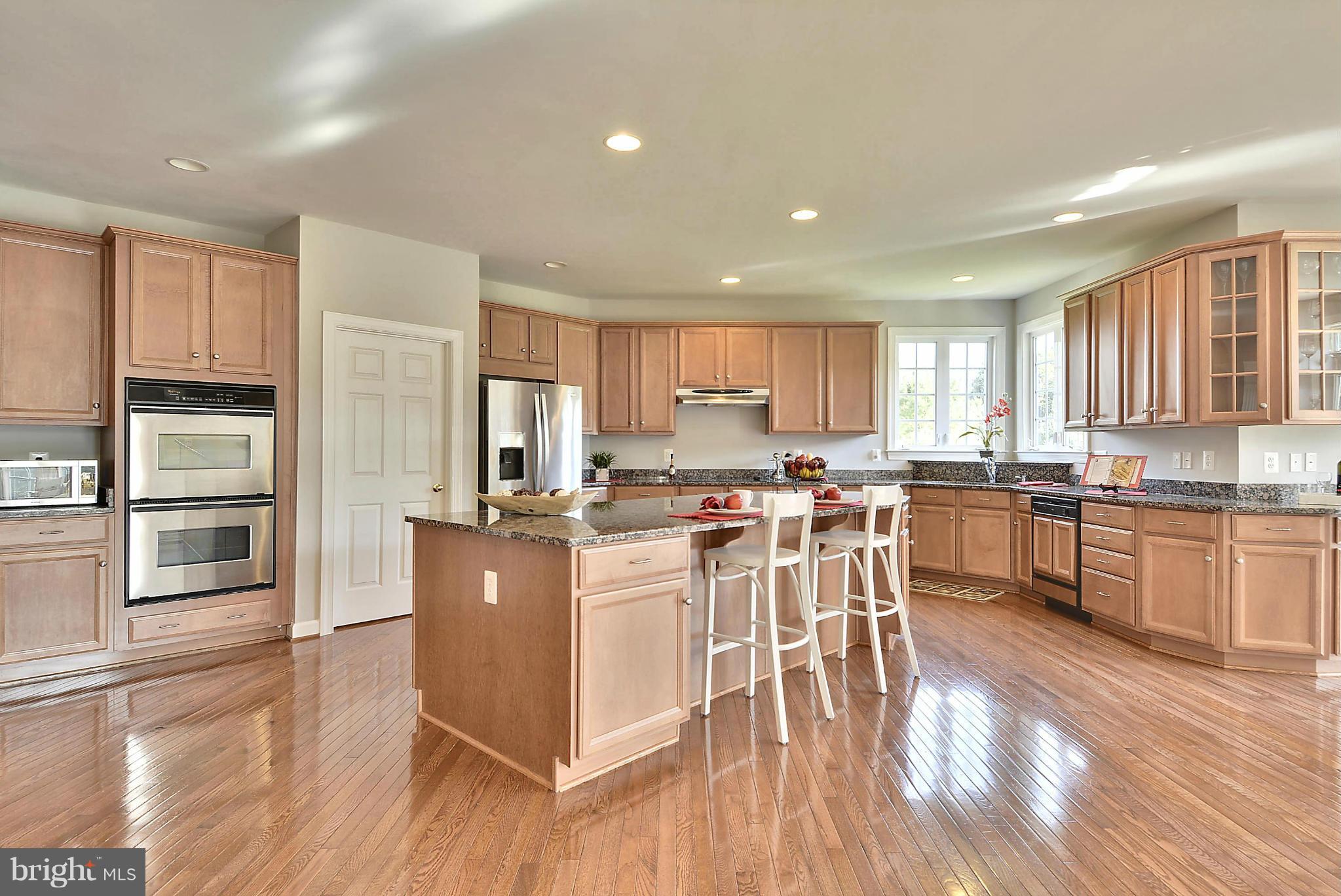 15429 Maple Ridge Drive Woodbine, MD 21797 - Photo 5 of 30 a kitchen with a sink a counter top space stainless steel appliances and cabinets