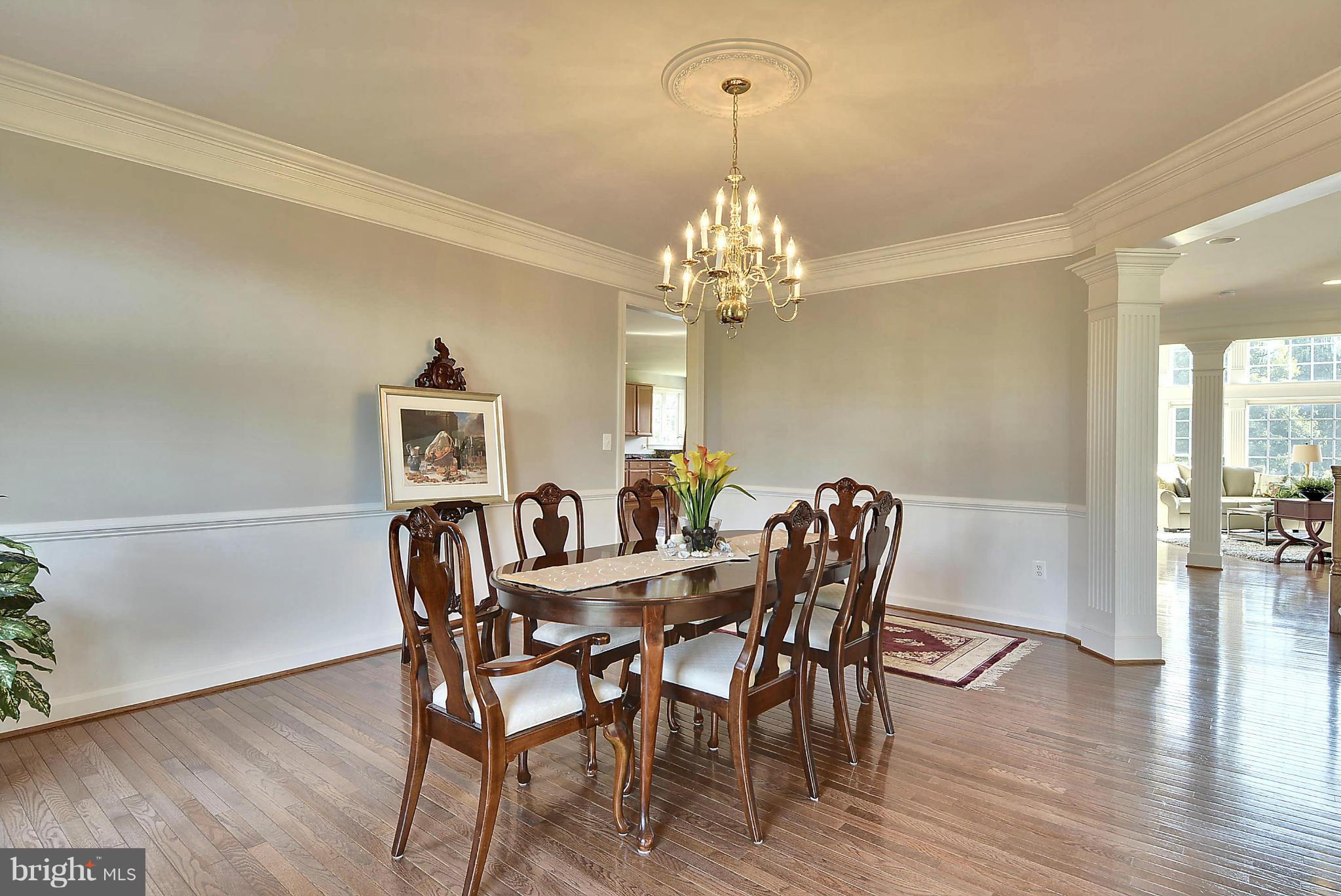 15429 Maple Ridge Drive Woodbine, MD 21797 - Photo 7 of 30 a view of a dining room with furniture wooden floor and chandelier