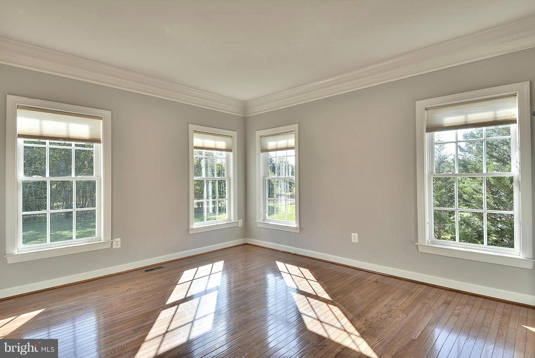 15429 Maple Ridge Drive Woodbine, MD 21797 - Photo 10 of 30 a view of an empty room with wooden floor and windows