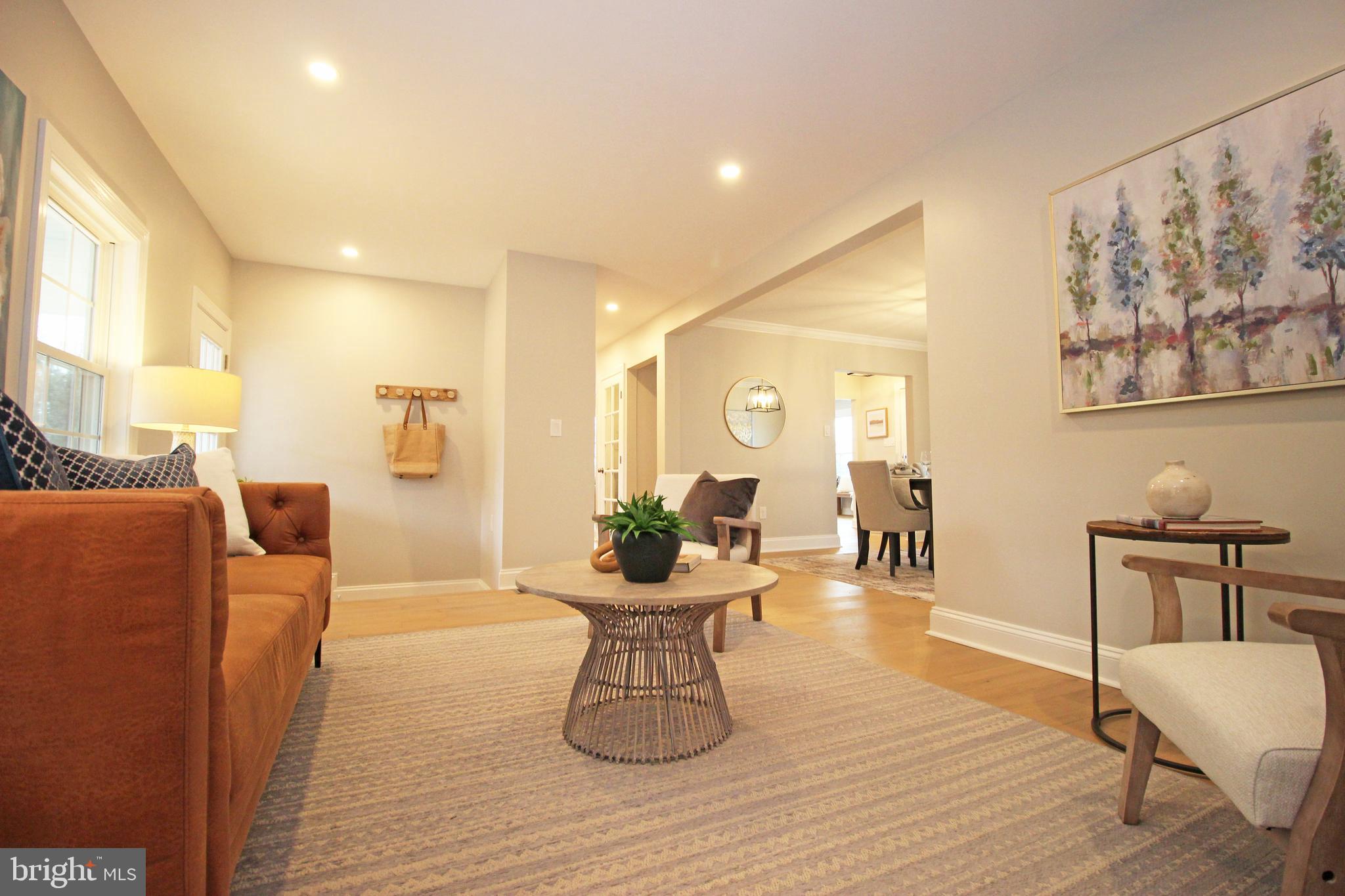 949 West Avenue Springfield, PA 19064 - Photo 23 of 42 a living room with furniture a wooden floor and a chandelier