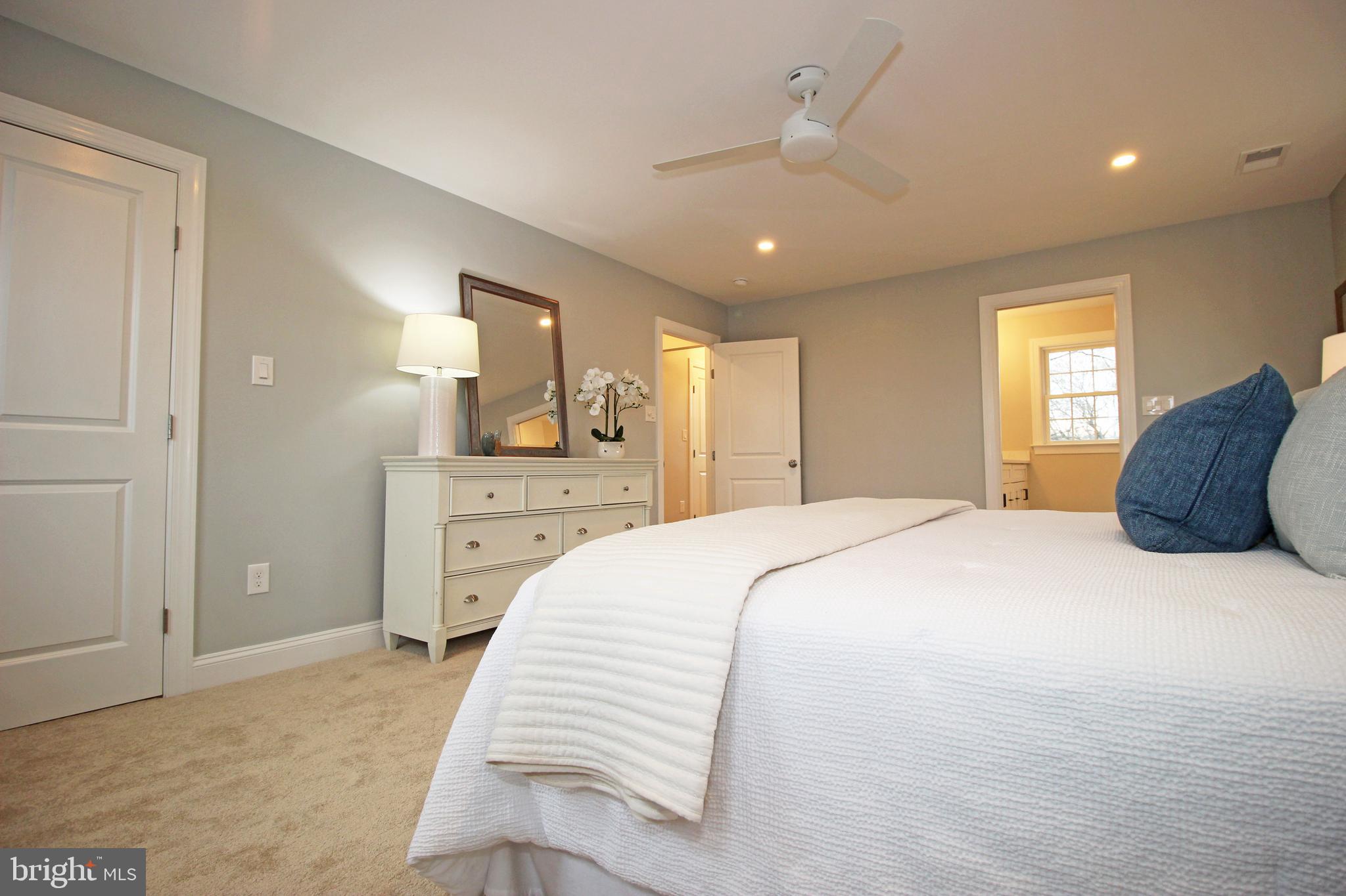 949 West Avenue Springfield, PA 19064 - Photo 29 of 42 a spacious bedroom with a bed and a dresser