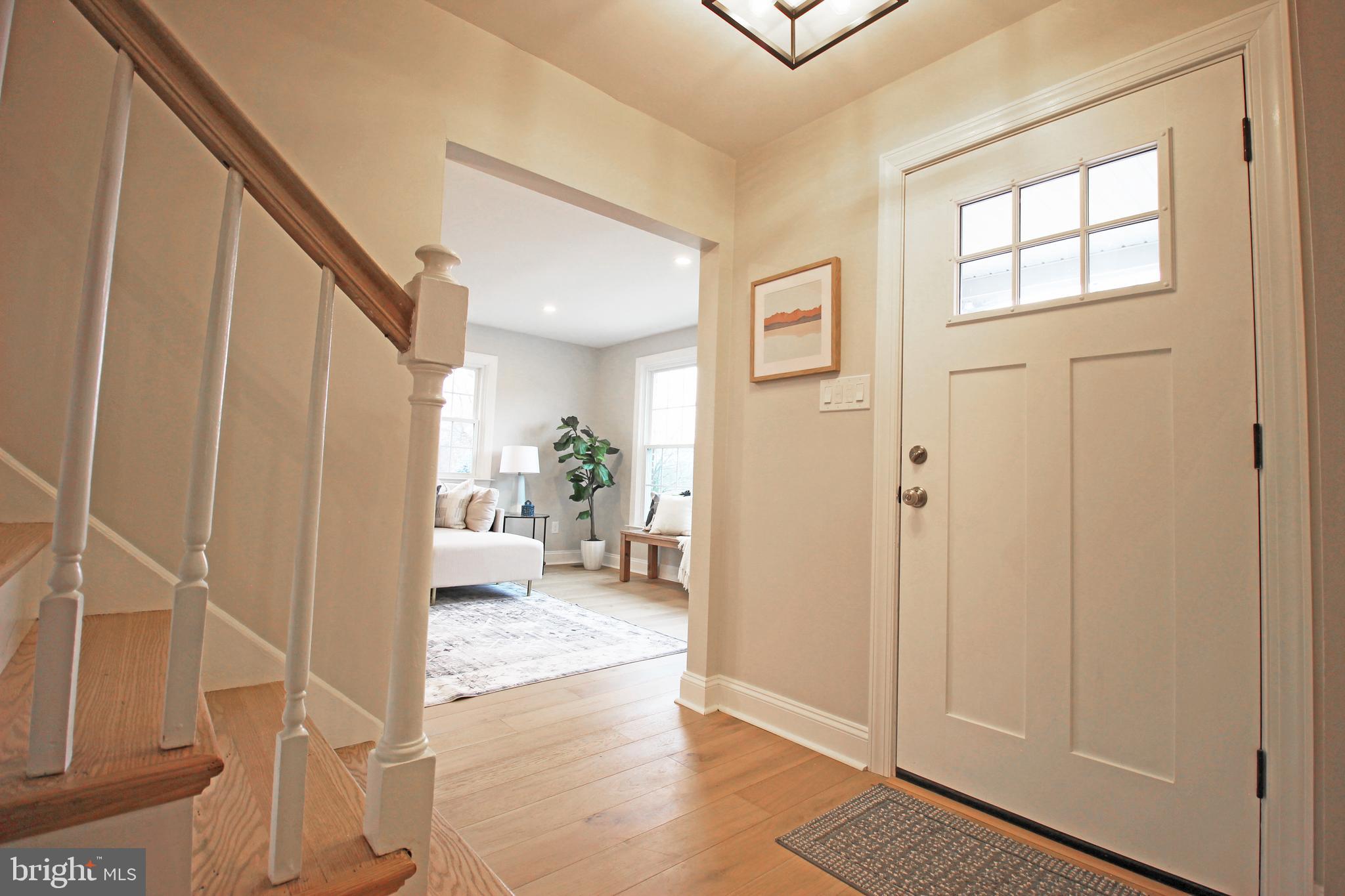 949 West Avenue Springfield, PA 19064 - Photo 4 of 42 a view of a hallway view with wooden floor and a living room