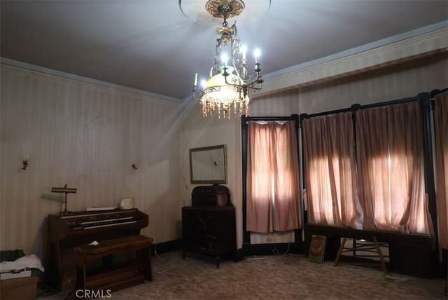 a view of a livingroom with furniture and a chandelier
