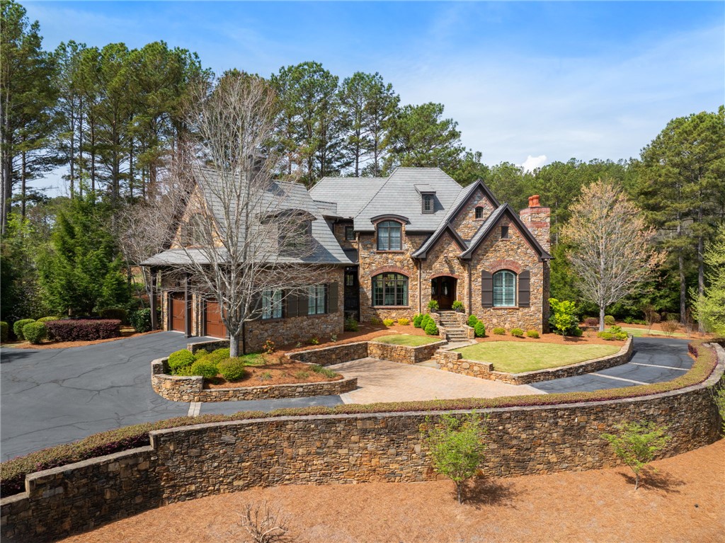 418 Augusta Way Sunset, SC 29685 - Photo 1 of 50 This majestic stone estate, nestled among towering trees, offers privacy and architectural elegance.