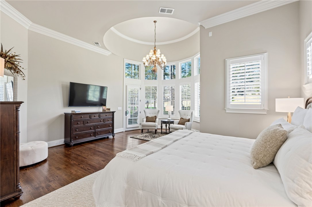 418 Augusta Way Sunset, SC 29685 - Photo 19 of 50 This primary bedroom offers high ceilings and rich hardwood flooring, creating an inviting retreat.