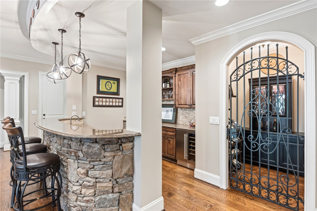 418 Augusta Way Sunset, SC 29685 - Photo 29 of 50 This exquisite space combines a bar with natural stone and a wine cellar featuring a wrought iron gate.