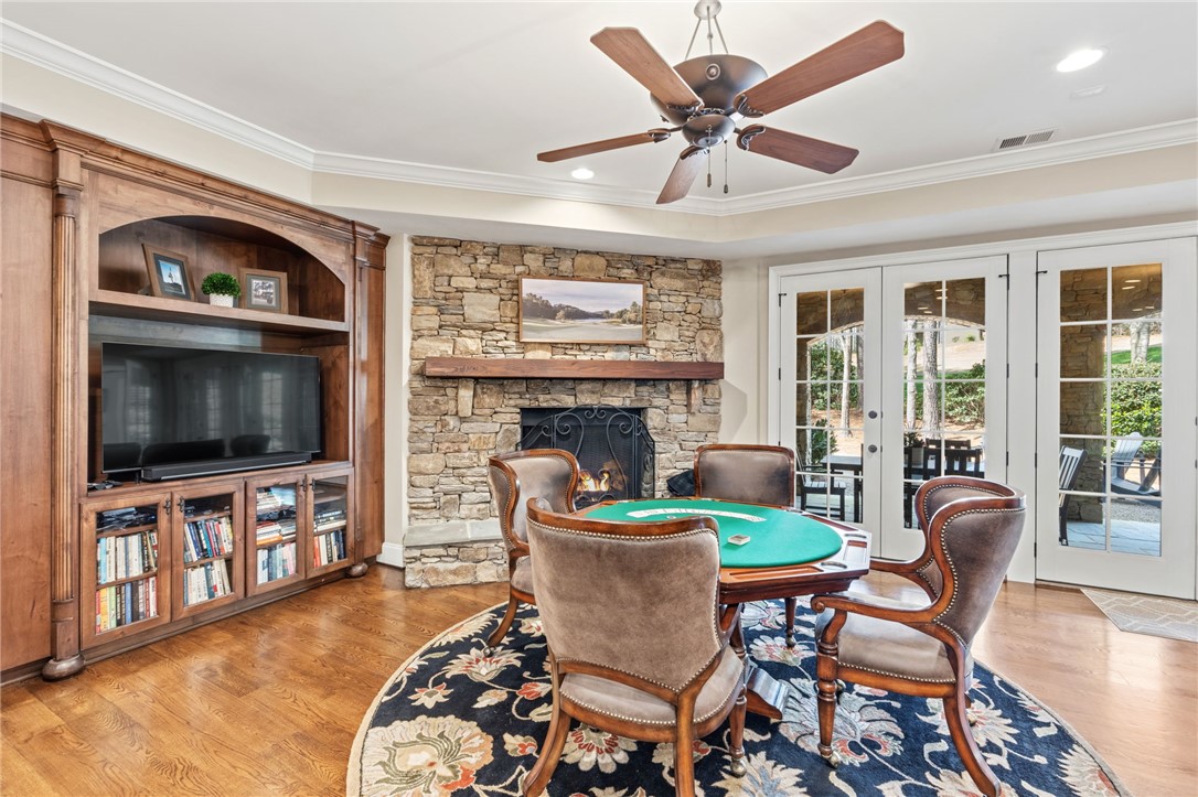 418 Augusta Way Sunset, SC 29685 - Photo 32 of 50 This inviting living space features warm hardwood floors and a cozy fireplace with direct outdoor access.