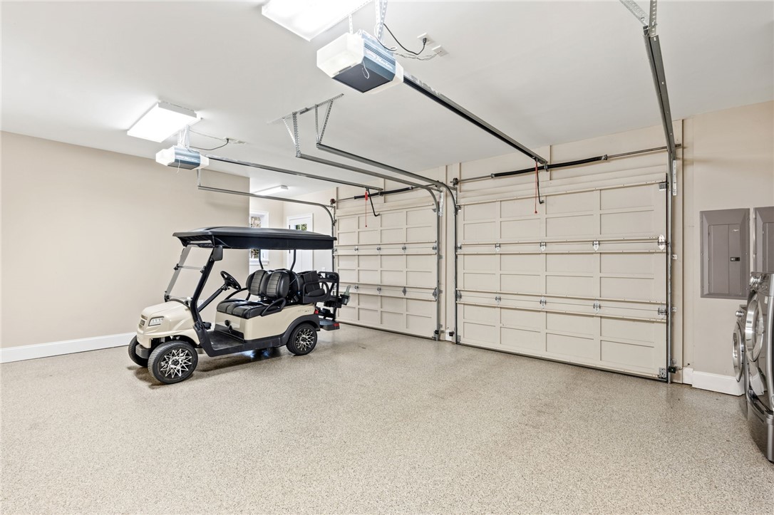 418 Augusta Way Sunset, SC 29685 - Photo 35 of 50 This spacious garage offers ample room for vehicles and storage, featuring durable flooring and automatic doors.