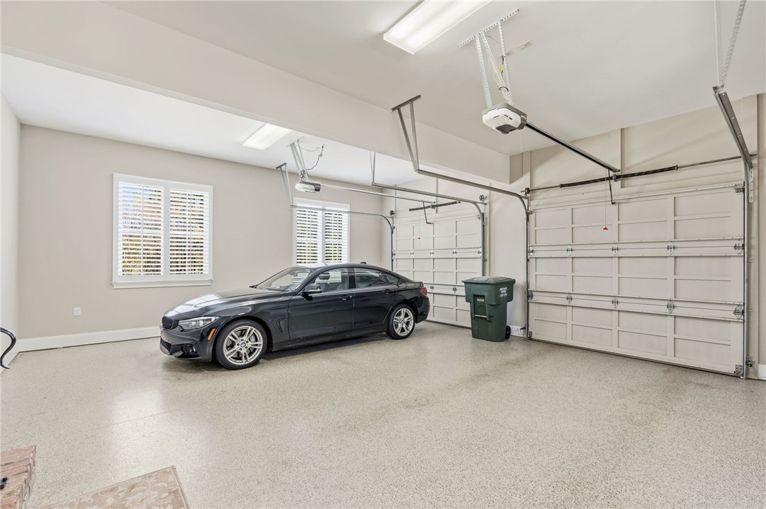418 Augusta Way Sunset, SC 29685 - Photo 41 of 50 This spacious garage offers ample room for vehicles and storage, featuring durable flooring and functional overhead doors.