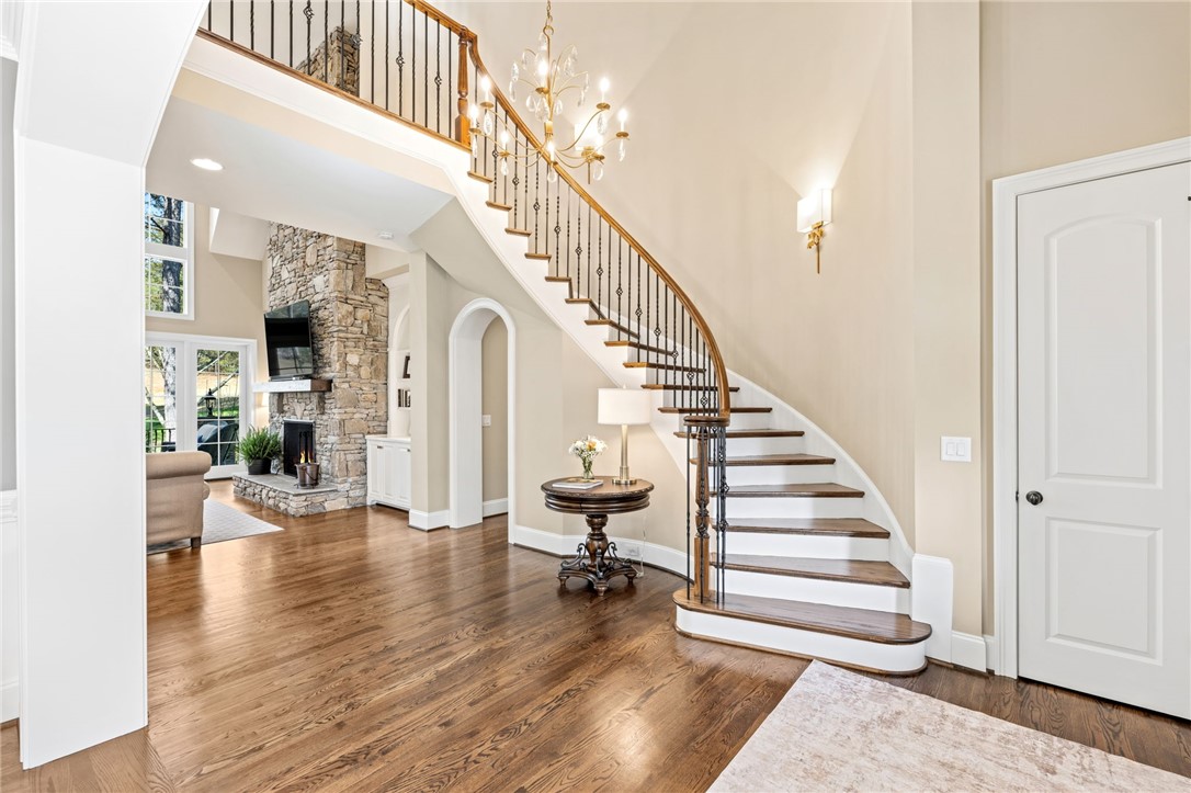 418 Augusta Way Sunset, SC 29685 - Photo 5 of 50 This grand entrance offers a sweeping staircase and a cozy fireplace, perfect for elegant living.
