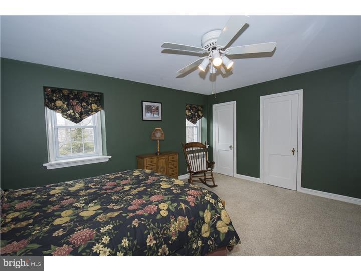 17 Braeburn Road Havertown, PA 19083 - Photo 16 of 25 a bedroom with a bed and a chandelier