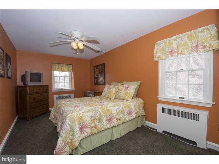 17 Braeburn Road Havertown, PA 19083 - Photo 18 of 25 a bedroom with a bed and a chandelier