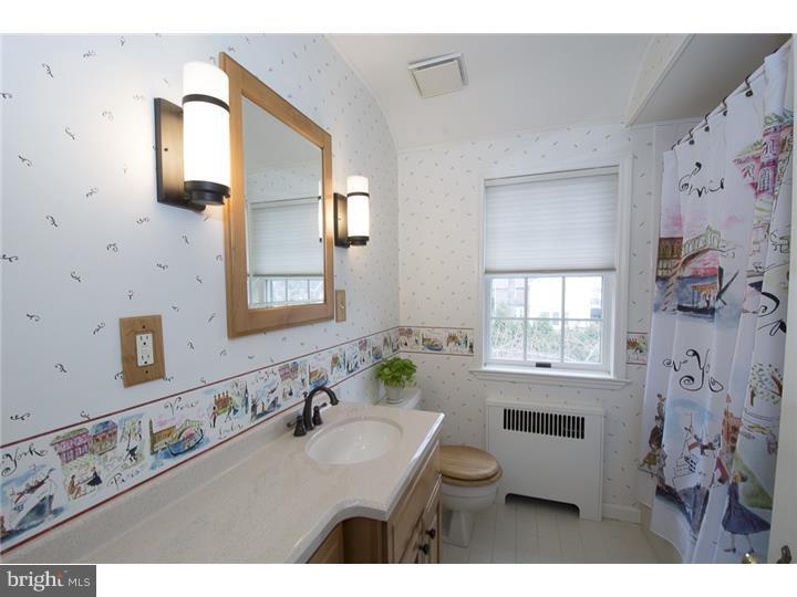 17 Braeburn Road Havertown, PA 19083 - Photo 20 of 25 a bathroom with a granite countertop sink a toilet a mirror and window