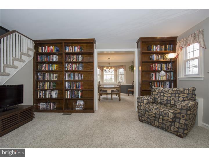 17 Braeburn Road Havertown, PA 19083 - Photo 6 of 25 a living room with furniture a bookshelf and a window