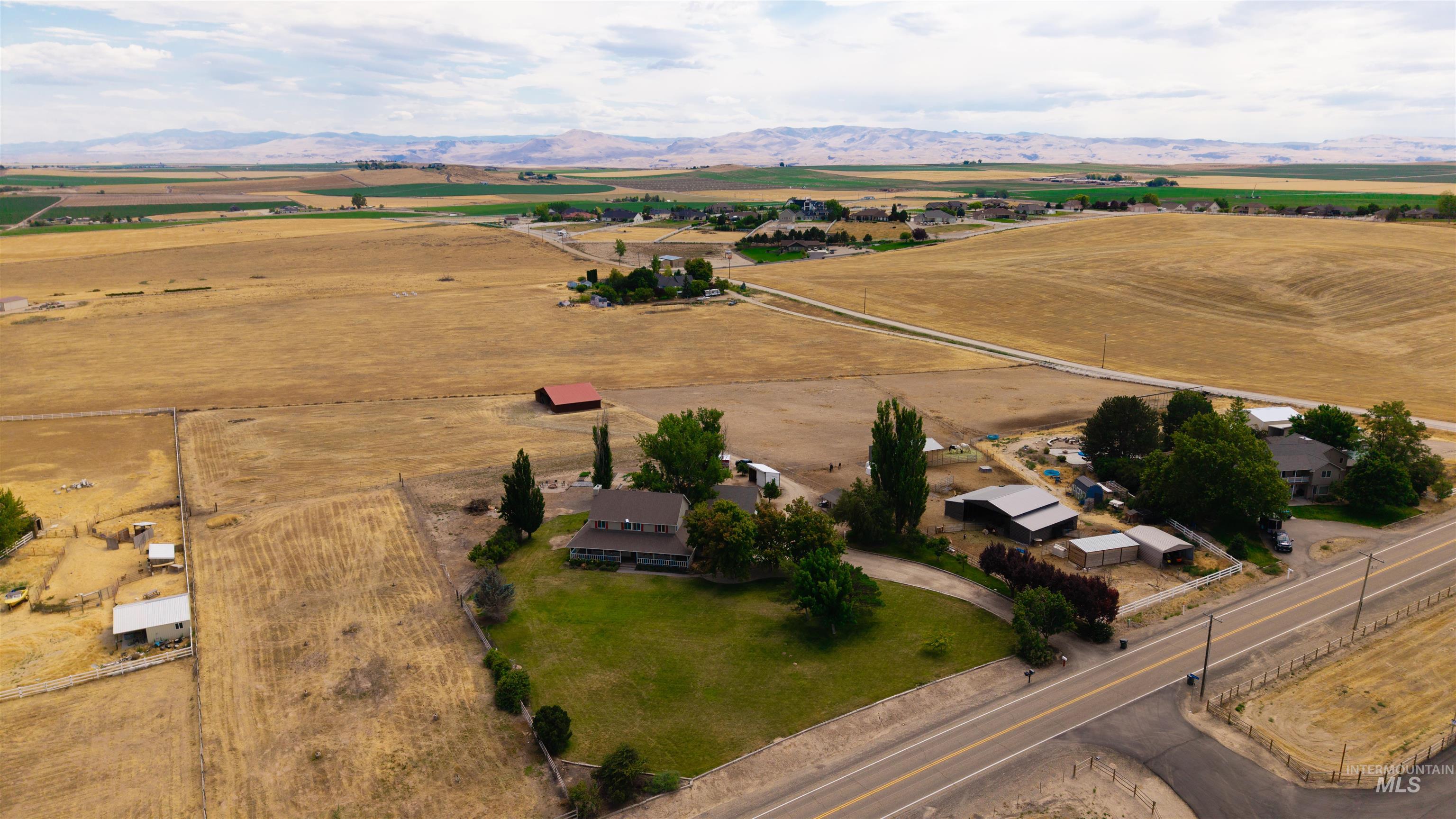 12369 Deer Flat Road Nampa, ID 83686 - Photo 43 of 50 Rural property featuring multiple outbuildings, mature trees, and a paved road frontage
