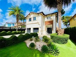 a front view of a house with a garden