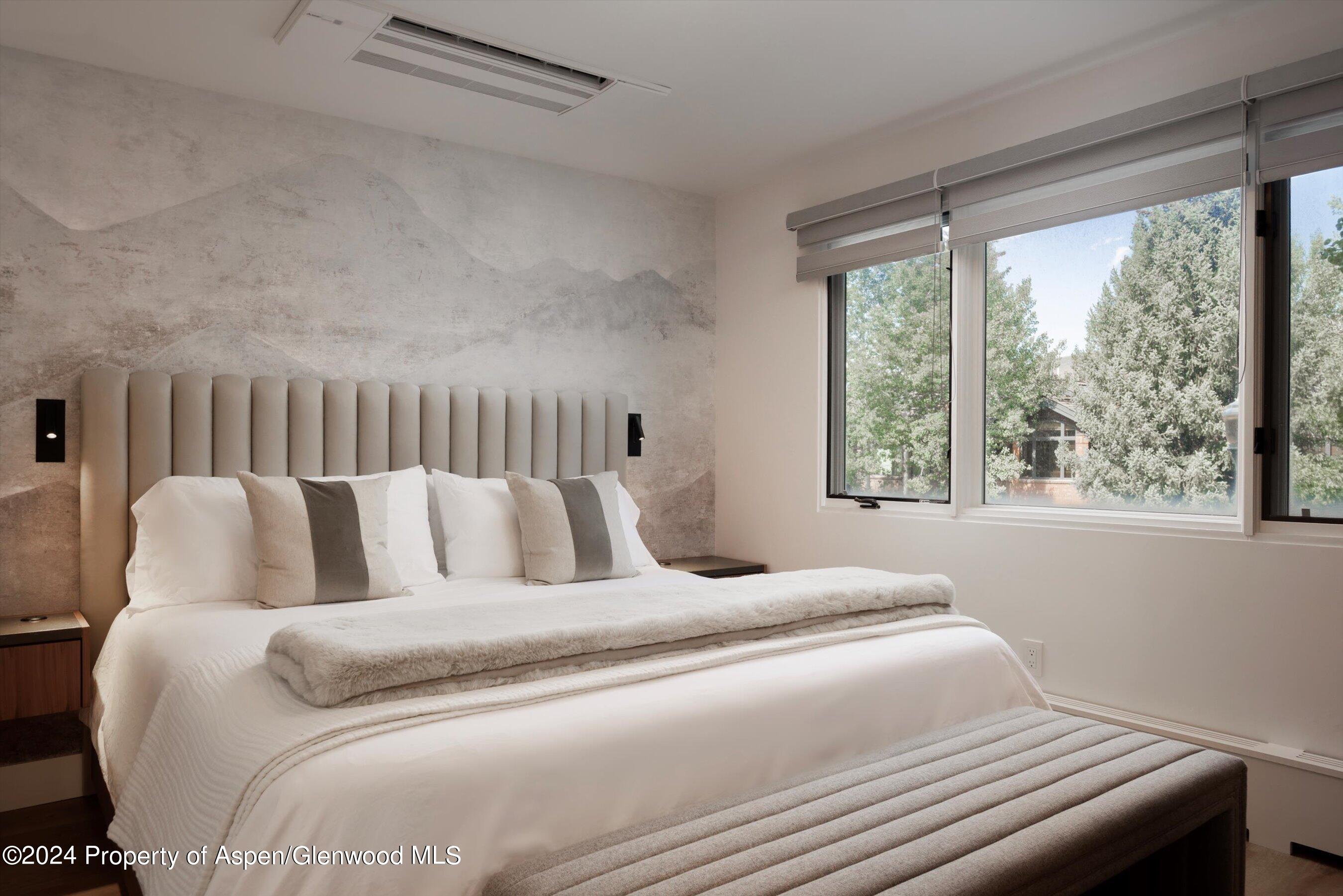 205 East Durant Avenue, Unit 1I Aspen, CO 81611 - Photo 18 of 45 a large bed sitting in a bedroom next to a window