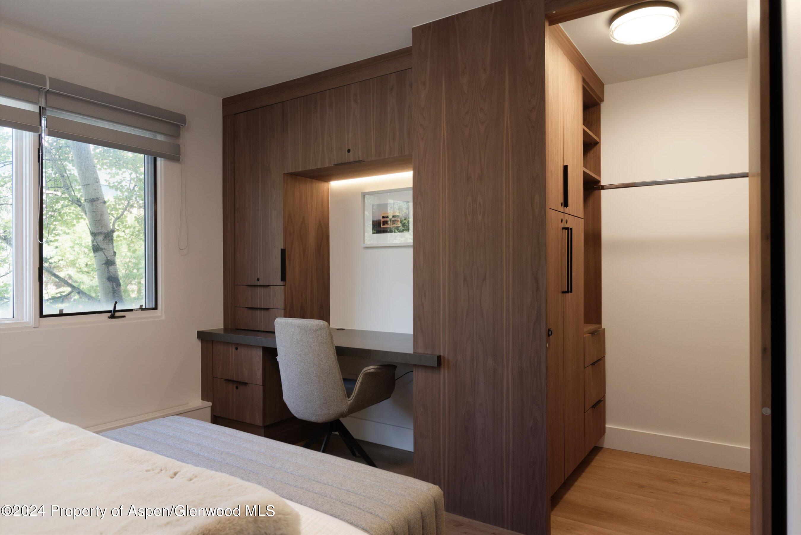 205 East Durant Avenue, Unit 1I Aspen, CO 81611 - Photo 19 of 45 a bedroom with a bed a mirror and a window