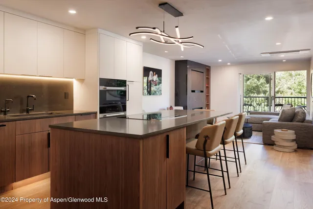 a kitchen with counter top space and dining table