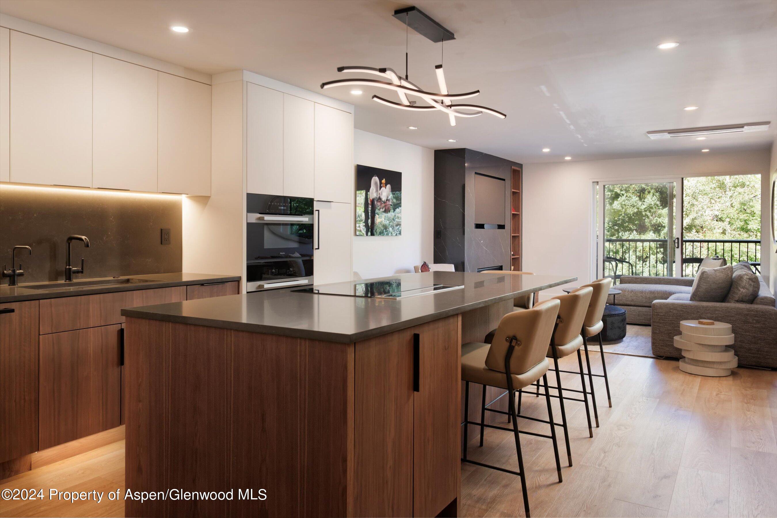 205 East Durant Avenue, Unit 1I Aspen, CO 81611 - Photo 2 of 45 a kitchen with counter top space and dining table